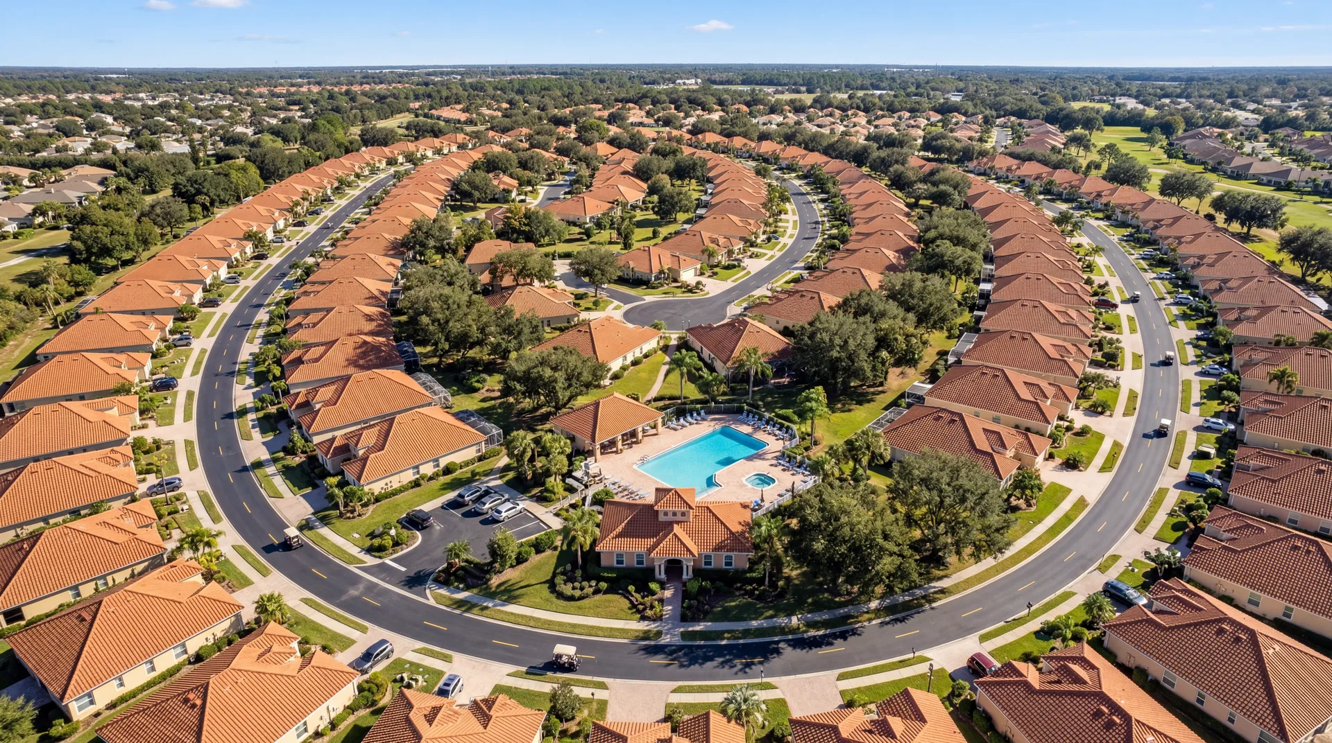 Aerial view of a Villages, FL neighborhood with golf cart paths and community pool